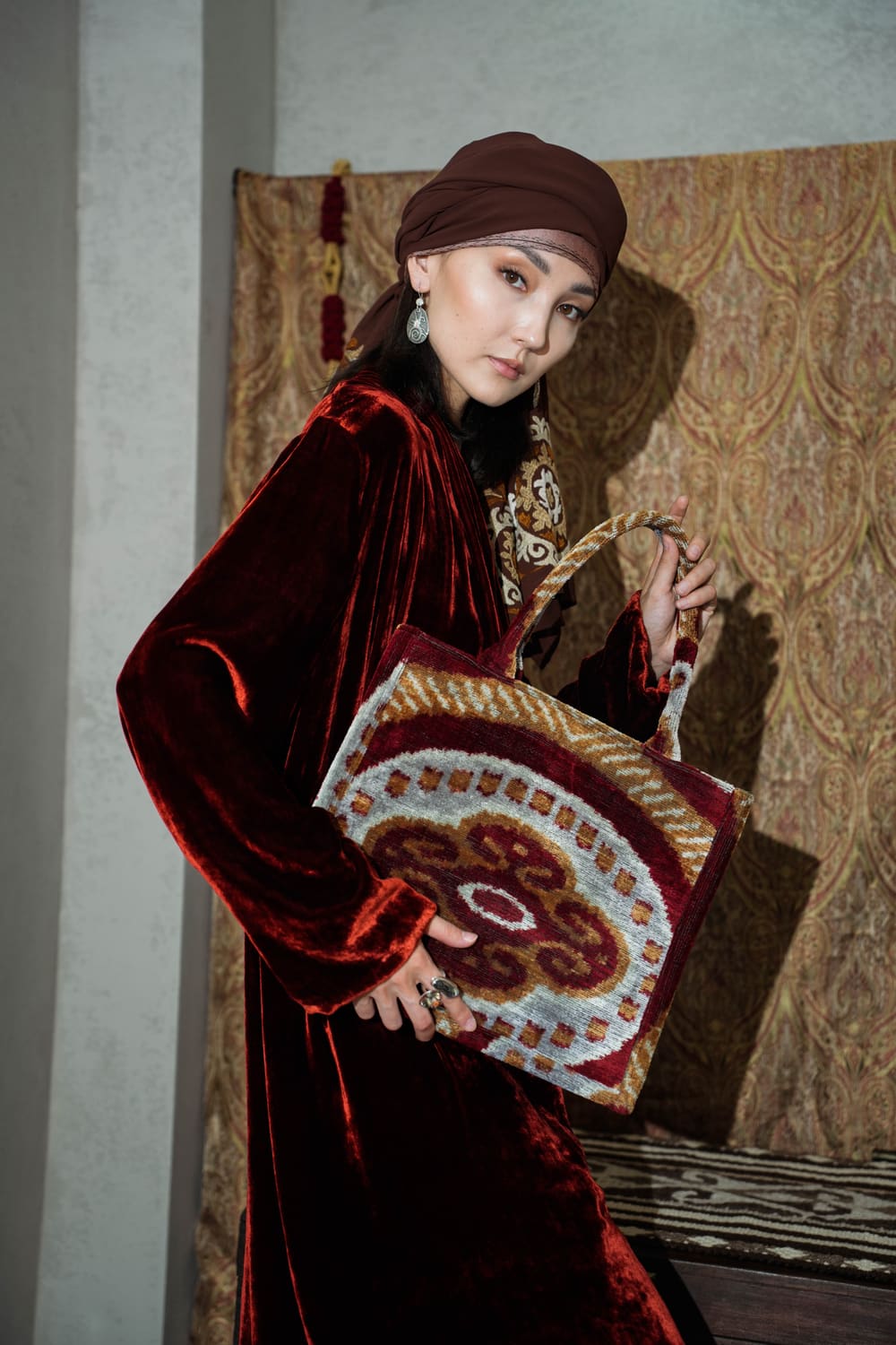 Deep red velvet TURANAI chapan with a velvet bag in ikat ornament