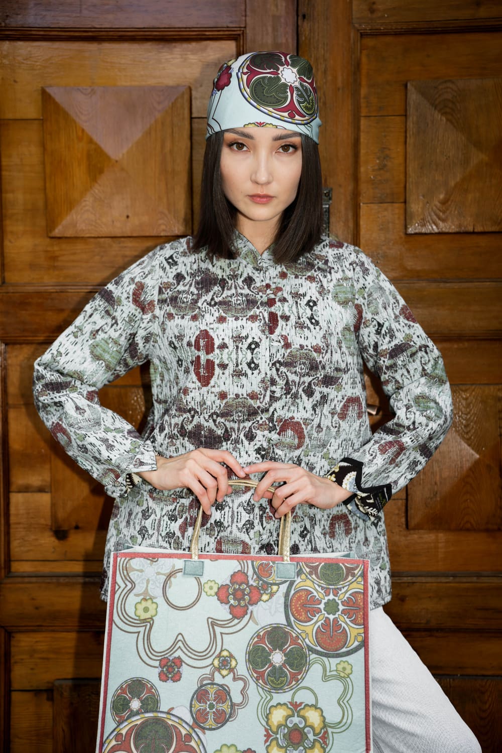 Printed TURANAI shirt, turban and ornamented tote against carved wooden doors