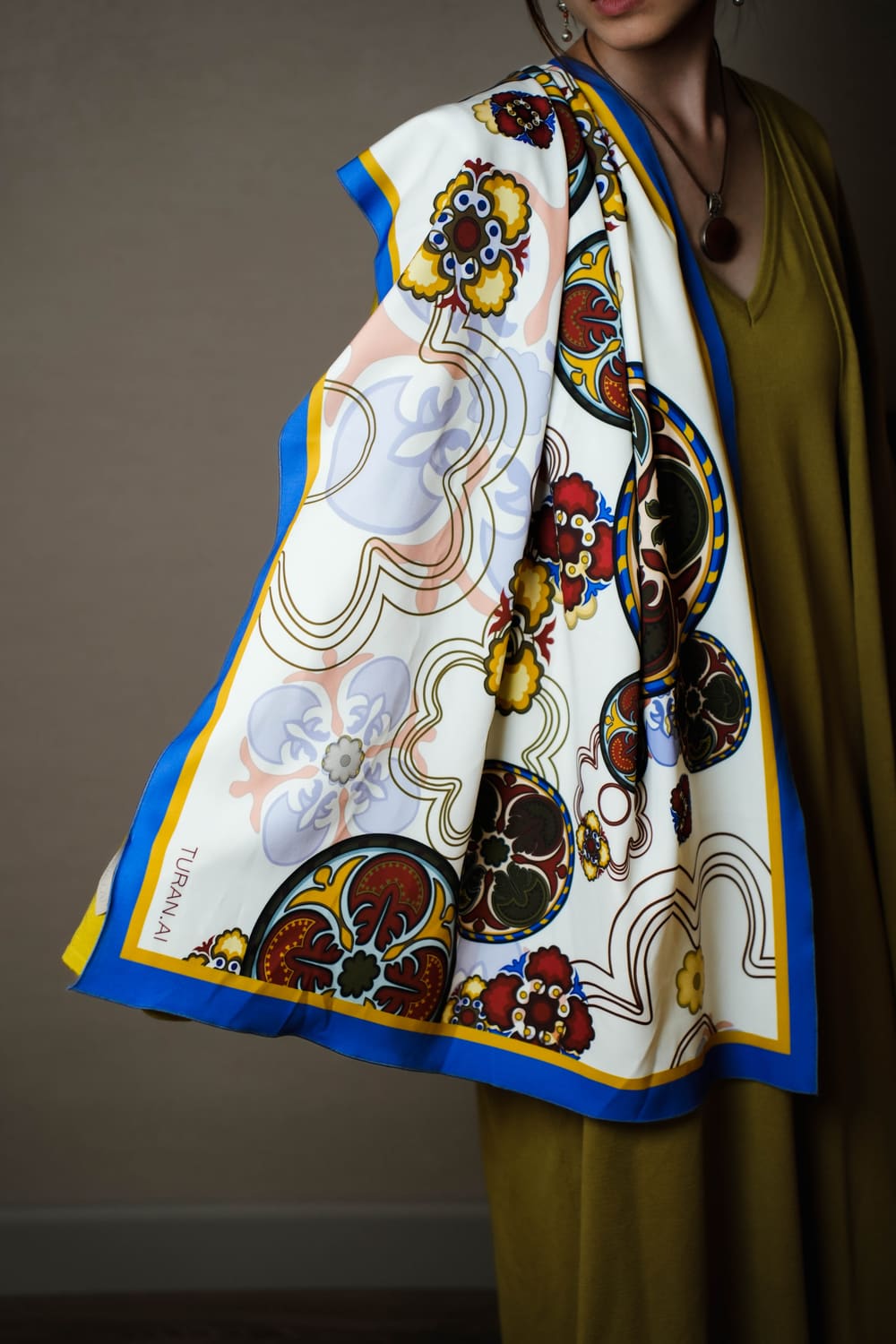 White TURANAI silk scarf with a blue border and botanical ornament